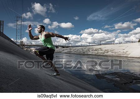 "Male runner running up steep river aquaduct, Los Angeles, California, USA" View Large Photo Image Stock Image - "Male runner running up steep river aquaduct, Los Angeles, California, USA". Fotosearch