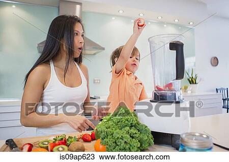 Male toddler putting strawberries into blender on kitchen counter View Large Photo Image Stock Image - Male toddler putting strawberries into blender on kitchen counter. Fotosearch