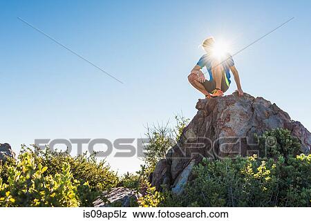 "Male trail runner looking down from rock on Pacific Crest Trail, Pine Valley, California, USA" View Large Photo Image Stock Photo - "Male trail runner looking down from rock on Pacific Crest Trail, Pine Valley, California, USA". Fotosearch