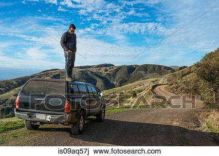 "Man looking down from top of pick up truck, Big Sur, California, USA" View Large Photo Image Stock Image - "Man looking down from top of pick up truck, Big Sur, California, USA". Fotosearch