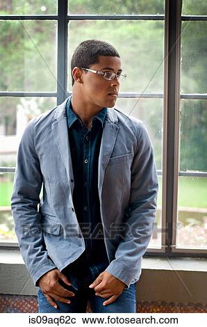 Mature teenage boy in front of window looking sideways View Large Photo Image Stock Image - Mature teenage boy in front of window looking sideways. Fotosearch