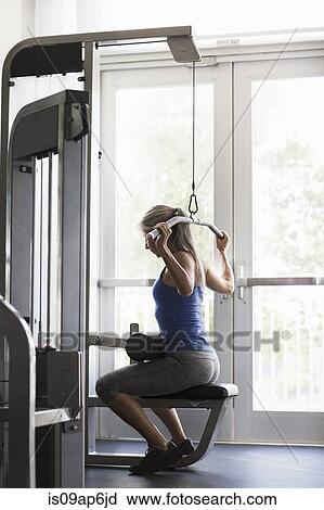 Mature woman training on gym machine View Large Photo Image Stock Image - Mature woman training on gym machine. Fotosearch