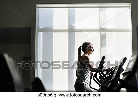 Mature woman training on gym machine View Large Photo Image Stock Image - Mature woman training on gym machine. Fotosearch