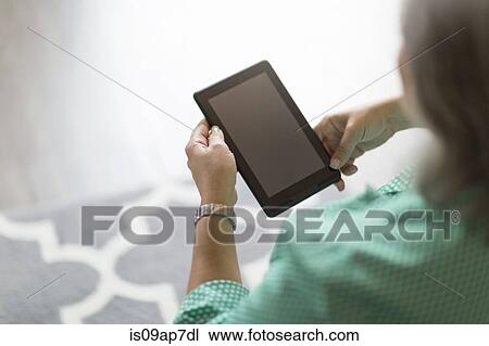 "Mature woman using digital tablet, rear view" View Large Photo Image Stock Image - "Mature woman using digital tablet, rear view". Fotosearch