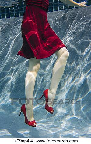 "Mature woman wearing red dress and high heels, underwater view, low section" View Large Photo Image Picture - "Mature woman wearing red dress and high heels, underwater view, low section". Fotosearch
