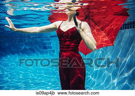 "Mature woman wearing red dress, holding red umbrella, underwater view, mid section" View Large Photo Image Stock Image - "Mature woman wearing red dress, holding red umbrella, underwater view, mid section". Fotosearch