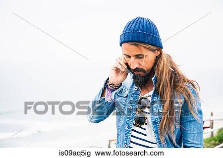 Mid adult man using cell phone View Large Photo Image Stock Image - Mid adult man using cell phone. Fotosearch