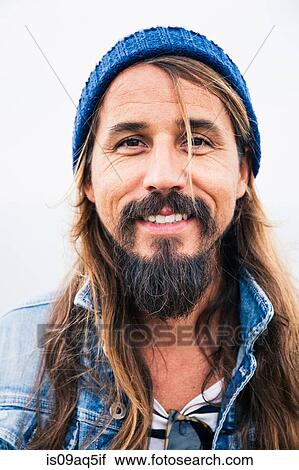 "Mid adult man with beard wearing hat, portrait" View Large Photo Image Stock Image - "Mid adult man with beard wearing hat, portrait". Fotosearch