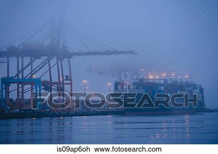"Misty view of cargo ship and cranes on waterfront at night, Seattle, Washington, USA" View Large Photo Image Stock Image - "Misty view of cargo ship and cranes on waterfront at night, Seattle, Washington, USA". Fotosearch