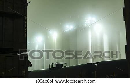 "Misty view of industrial storage tanks between locomotive at night, Seattle, Washington, USA" View Large Photo Image Stock Image - "Misty view of industrial storage tanks between locomotive at night, Seattle, Washington, USA". Fotosearch