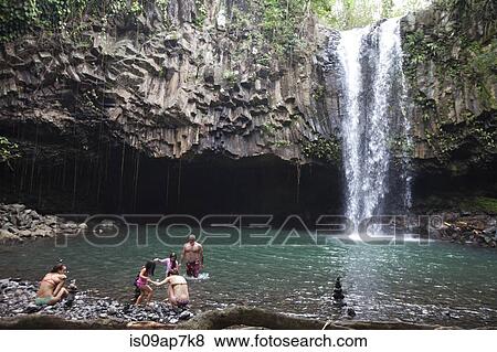 People swimming by waterfall View Large Photo Image Stock Photo - People swimming by waterfall. Fotosearch