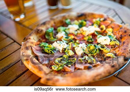 Plate of fresh pizza on restaurant table View Large Photo Image Stock Photography - Plate of fresh pizza on restaurant table. Fotosearch