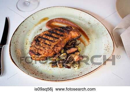Plate with grilled meat on restaurant table View Large Photo Image Stock Image - Plate with grilled meat on restaurant table. Fotosearch
