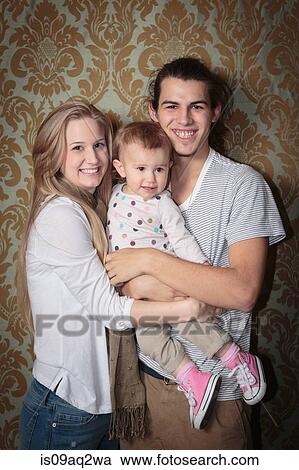 Portrait of a happy young family View Large Photo Image Stock Image - Portrait of a happy young family. Fotosearch