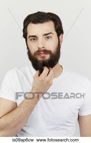 Portrait of bearded man in white t-shirt View Large Photo Image Stock Photo - Portrait of bearded man in white t-shirt. Fotosearch