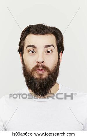 Stock Photo - Portrait of bearded man in white t-shirt. Fotosearch