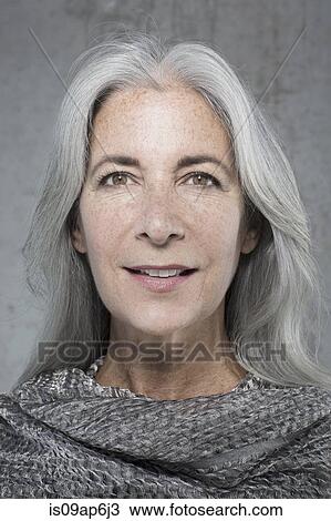 Stock Image - Portrait of beautiful mature woman with long grey hair. Fotosearch