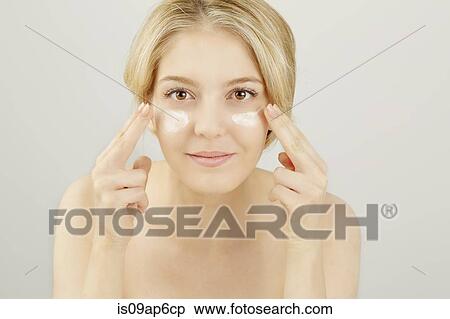 Portrait of blonde woman applying face cream View Large Photo Image Stock Photography - Portrait of blonde woman applying face cream. Fotosearch