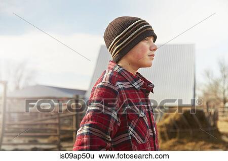 Portrait of boy wearing knit hat in dairy farm yard View Large Photo Image Stock Photograph - Portrait of boy wearing knit hat in dairy farm yard. Fotosearch