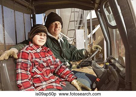 Stock Photography - Portrait of father and son dairy farmers in lorry. Fotosearch
