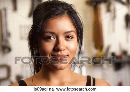 Stock Image - Portrait of female mechanic in workshop. Fotosearch
