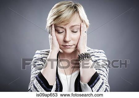 "Portrait of mature woman, hands at side of head" View Large Photo Image Stock Image - "Portrait of mature woman, hands at side of head". Fotosearch