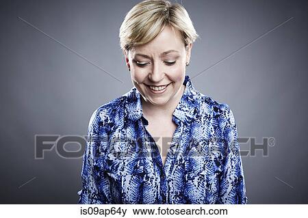 "Portrait of mature woman, looking down, smiling" View Large Photo Image Stock Photo - "Portrait of mature woman, looking down, smiling". Fotosearch