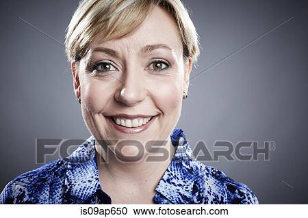 "Portrait of mature woman, smiling, close-up" View Large Photo Image Stock Image - "Portrait of mature woman, smiling, close-up". Fotosearch