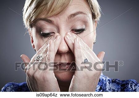 "Portrait of mature woman, wiping away tears from eyes" View Large Photo Image Stock Photo - "Portrait of mature woman, wiping away tears from eyes". Fotosearch