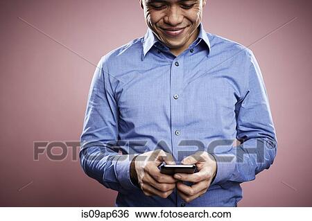 Portrait of mid adult man using smartphone View Large Photo Image Stock Photograph - Portrait of mid adult man using smartphone. Fotosearch