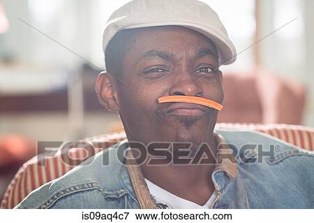 Stock Photo - Portrait of mid adult man with carrot mustache. Fotosearch