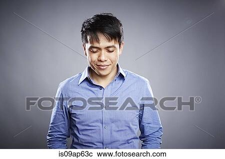 Stock Image - Portrait of mid adult man with pensive expression. Fotosearch