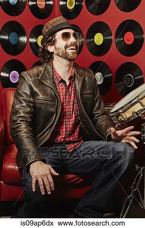 "Portrait of musician, vinyl records on background wall" View Large Photo Image Stock Photo - "Portrait of musician, vinyl records on background wall". Fotosearch