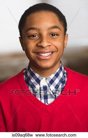Portrait of smiling teenage boy wearing red sweater View Large Photo Image Stock Photo - Portrait of smiling teenage boy wearing red sweater. Fotosearch