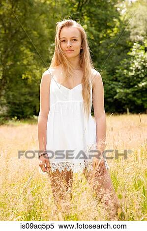 Portrait of teenage girl standing in field View Large Photo Image Stock Photography - Portrait of teenage girl standing in field. Fotosearch