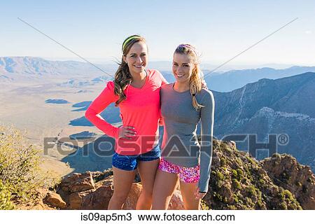 Stock Image - "Portrait of two female trail running friends on Pacific Crest Trail, Pine Valley, California, USA". Fotosearch