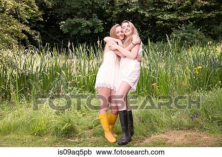 "Portrait of two teenage girls in field, hugging" View Large Photo Image Stock Image - "Portrait of two teenage girls in field, hugging". Fotosearch