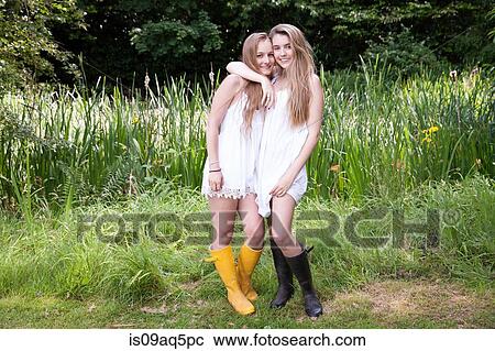 "Portrait of two teenage girls in field, hugging" View Large Photo Image Stock Image - "Portrait of two teenage girls in field, hugging". Fotosearch