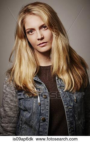 Stock Image - Portrait of woman in denim jacket. Fotosearch
