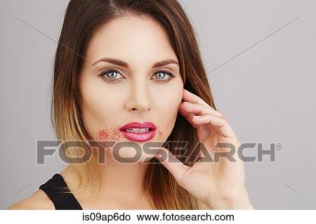 Picture - Portrait of woman with sugar around lips. Fotosearch