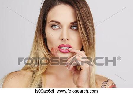 Stock Image - Portrait of woman with sugar around lips. Fotosearch
