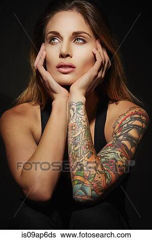 Portrait of woman with tattooed arms View Large Photo Image Stock Photograph - Portrait of woman with tattooed arms. Fotosearch