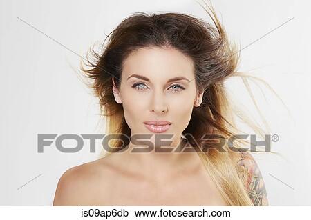 Stock Image - Portrait of woman with windblown hair. Fotosearch