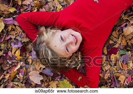 "Portrait of young girl, lying in autumn leaves" View Large Photo Image Stock Photography - "Portrait of young girl, lying in autumn leaves". Fotosearch