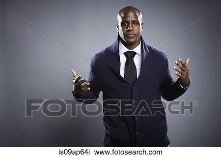 Stock Image - "Portrait of young man, hands open in questioning expression". Fotosearch