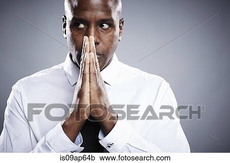 "Portrait of young man, hands together in praying position" View Large Photo Image Stock Image - "Portrait of young man, hands together in praying position". Fotosearch