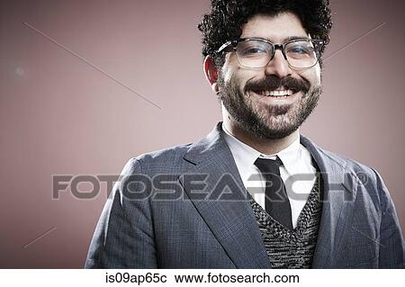Stock Image - "Portrait of young man, looking at camera, smiling". Fotosearch