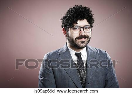 Stock Image - "Portrait of young man, looking at camera, smiling". Fotosearch