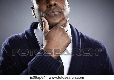 Portrait of young man with hand on chin View Large Photo Image Stock Image - Portrait of young man with hand on chin. Fotosearch