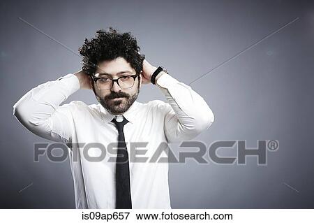 Portrait of young man with hands behind head View Large Photo Image Stock Photo - Portrait of young man with hands behind head. Fotosearch
